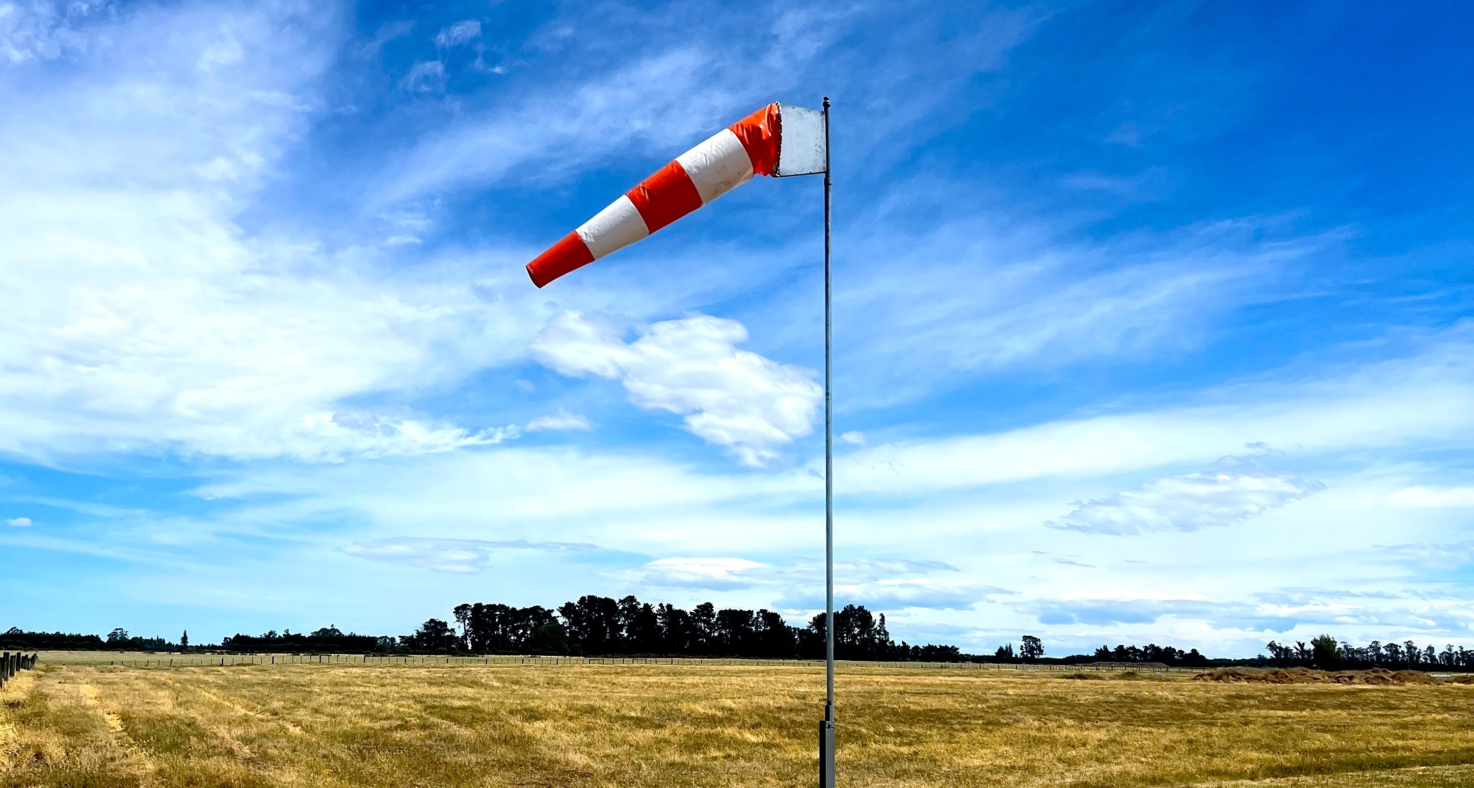 aerosew-striped-windsock-with-grass-paddock-in-background