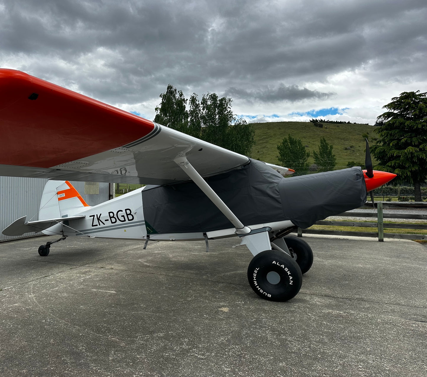 Bearhawk-4B-aircraft-outside-hangar-with-grey-aerosew-canopy-cover-on