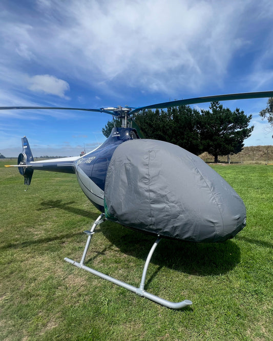 Cabri-helicopter-on-grass-with-grey-aerosew-cover-on
