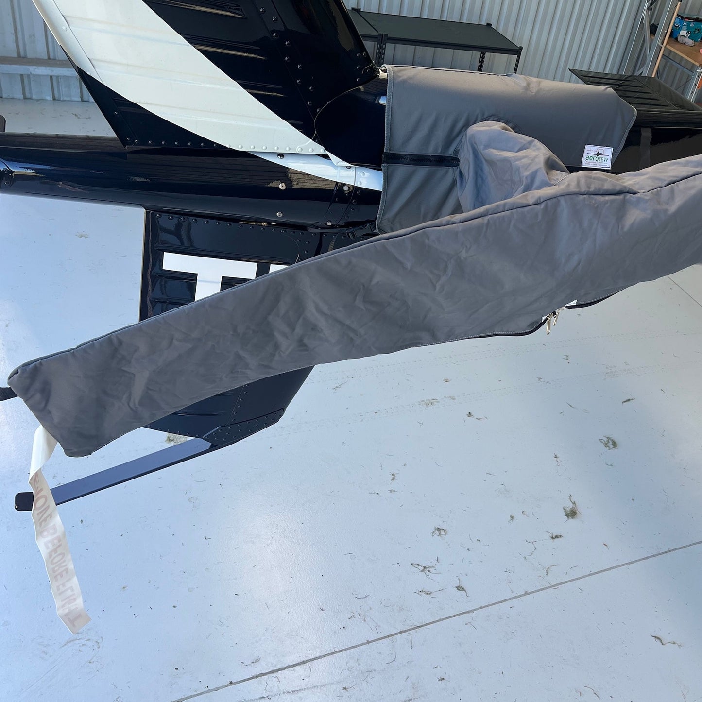 Charcoal Aerosew tail rotor cover with full-length blade sleeves fitted to a black H125 helicopter.