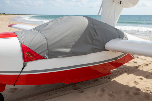 Lake_amphibian-aircraft-on-golden-beach-with-grey-aerosew-cover-on