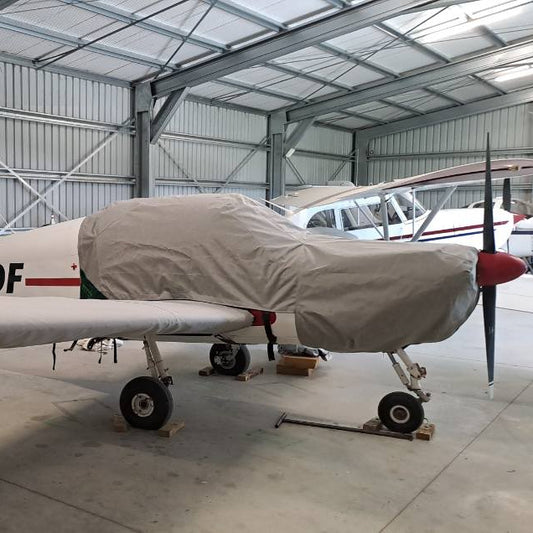 Rallye-aircraft-in-hangar-with-light-grey-aerosew-cover-on
