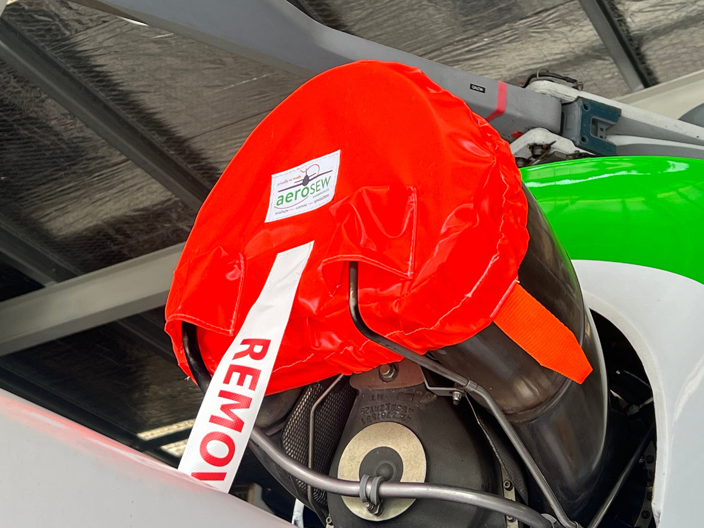 orange-exhaust-cover-on-squirrel-helicopter-close-up-in-hangar