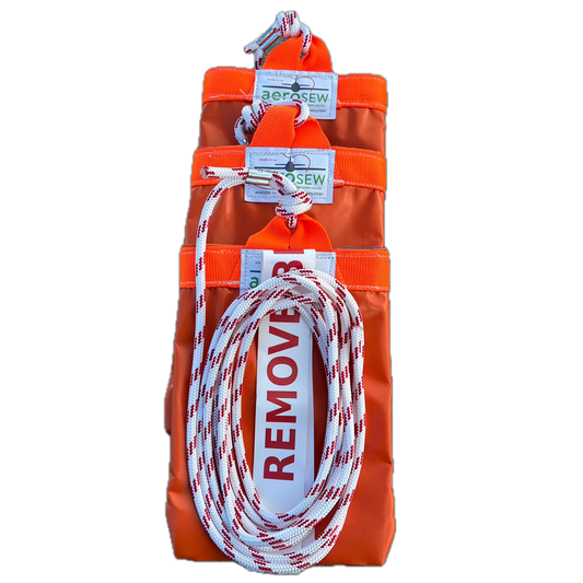 Set of three orange Aerosew PVC rotor blade tie-downs for a Cabri G2, with red-and-white rope and Remove Before Flight streamers.