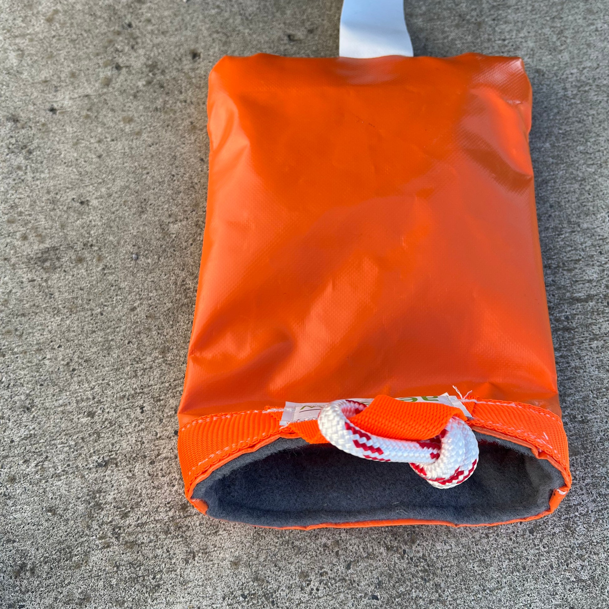 Close-up of the soft-lined opening and rope attachment on an orange Cabri G2 PVC rotor blade tie-down.