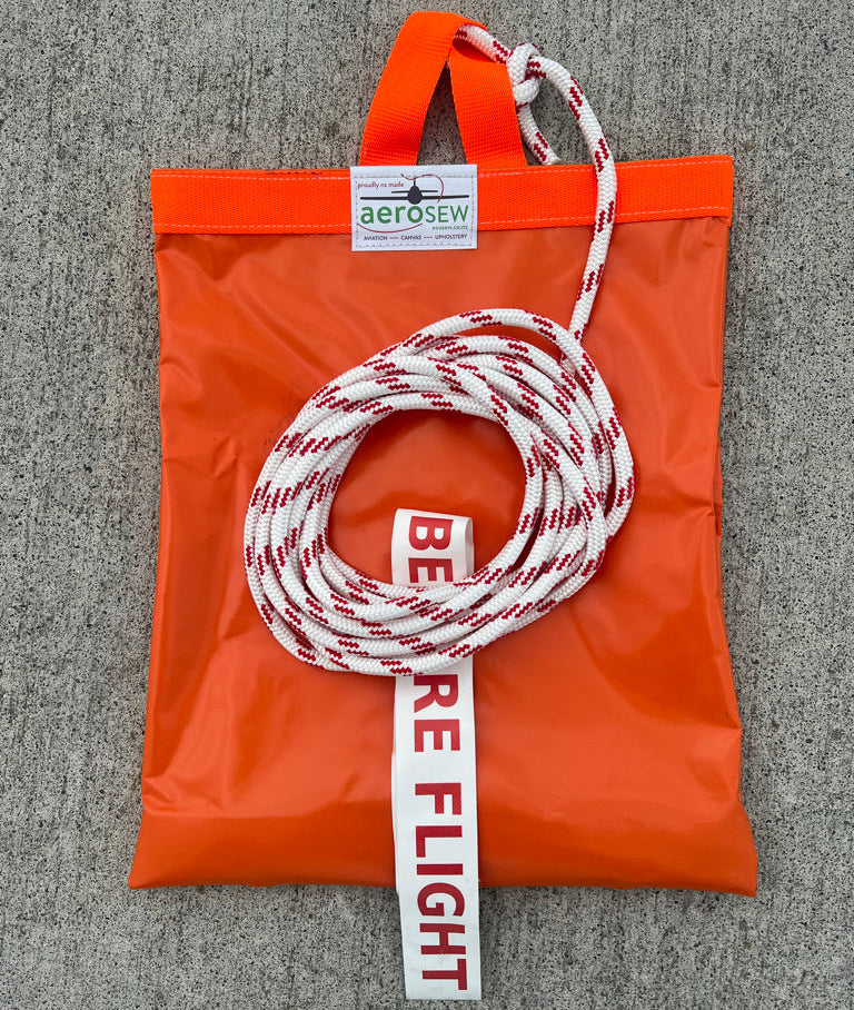 Orange Aerosew PVC rotor blade tie-down for a Safari helicopter with red-and-white yachting rope and Remove Before Flight streamer.