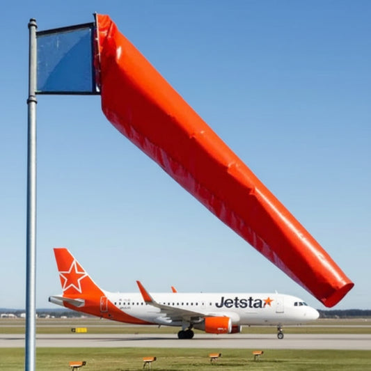 large-close-up-orange-windsock-jetstar aircraft-in-background