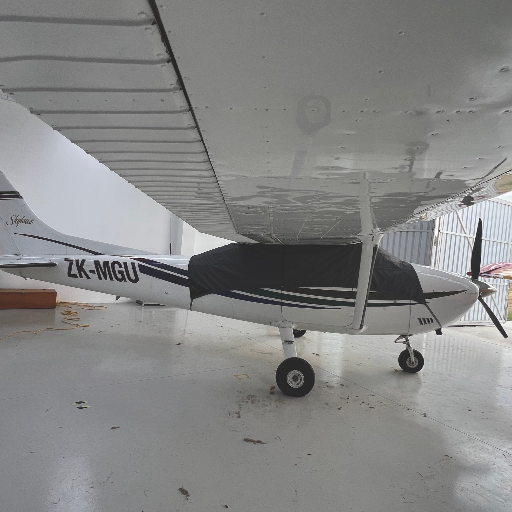 Cessna 182 right hand side in hangar with grey aerosew half cover fitted