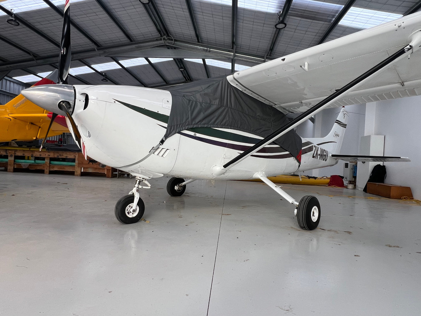 cessna 182 in hangar with aeerosew half cover on