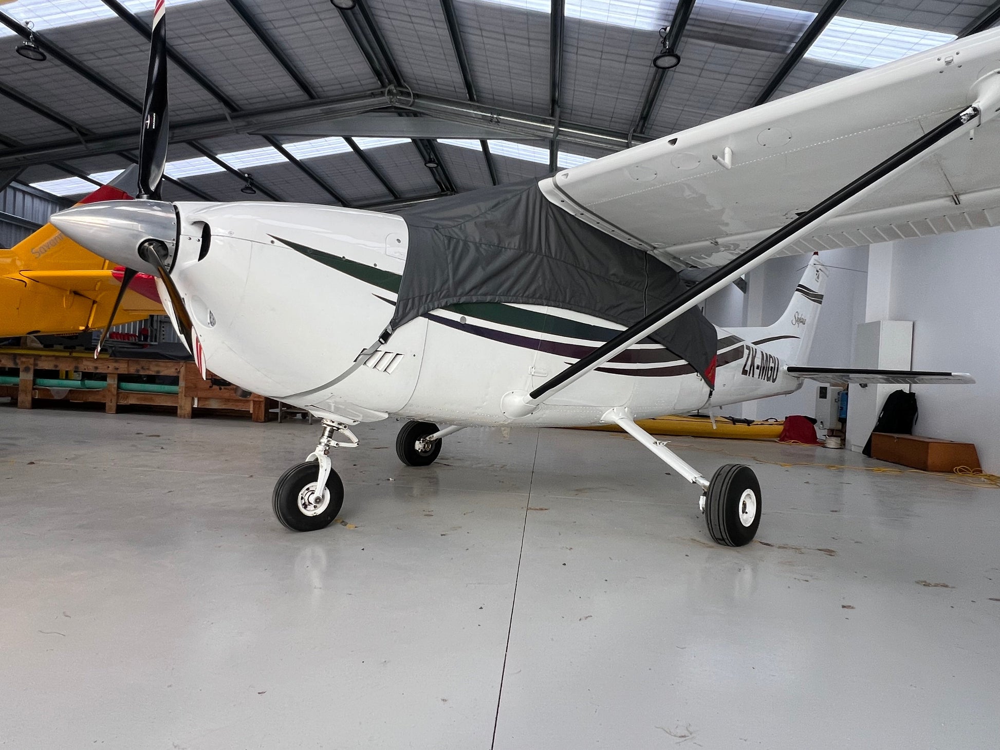 cessna 182 in hangar with aeerosew half cover on