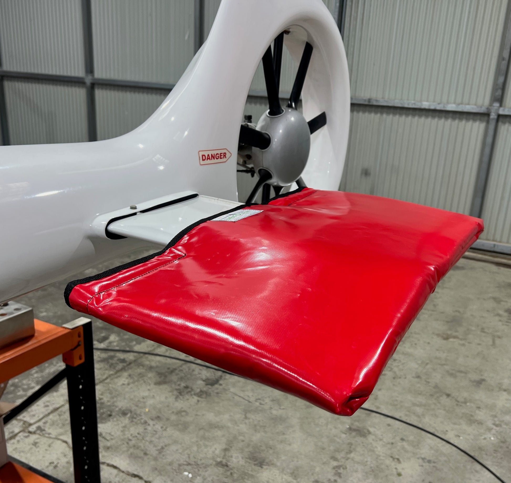 Close-up of a red padded PVC cover protecting the horizontal stabiliser of a helicopter.